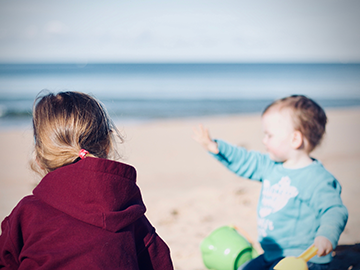 Young girl and boy at the beach